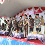 Bupati Sampang H. Slamet Junaidi mengangkat bendera bersama Wabup Sampang serta Forkopimda dan jajaran Pemkab Sampang berdiri melepas CJH Sampang.
